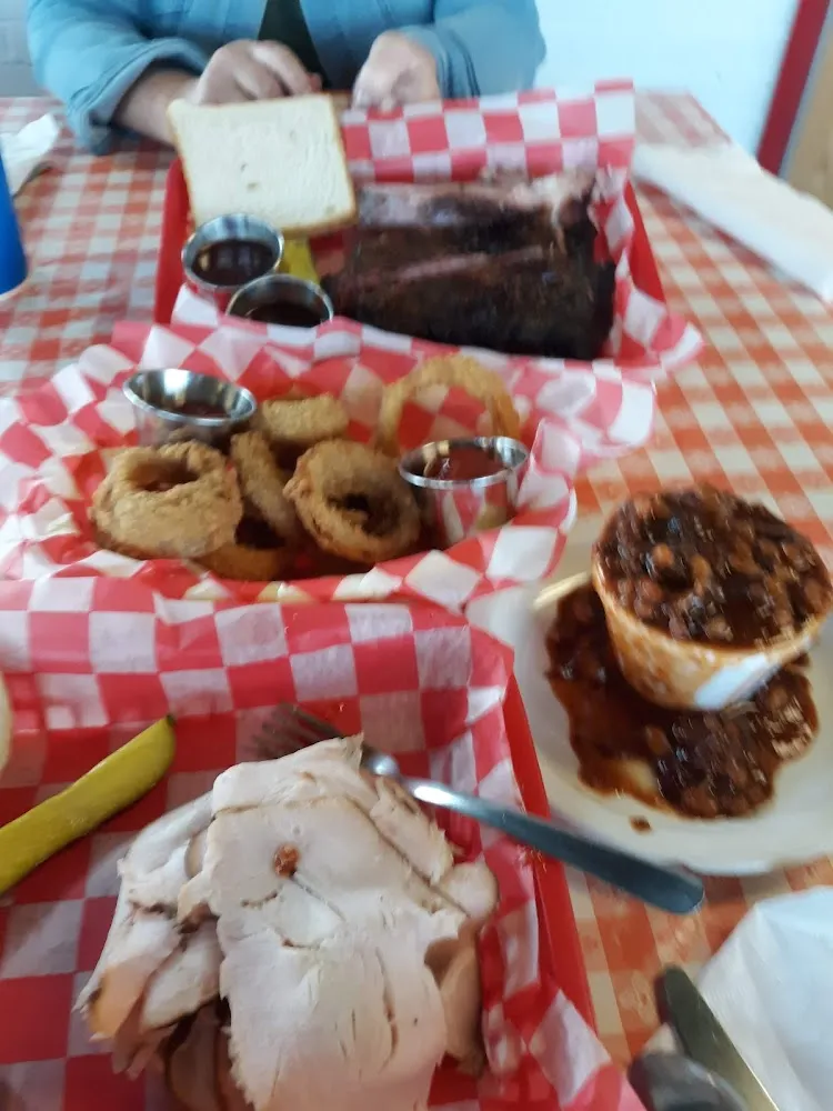 Turkey Sandwich with Bean & Onion Rings Ribs in the Background